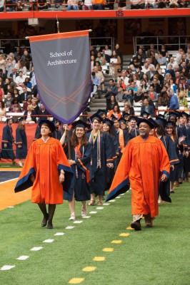 Class marshal Angela Copes ’17 carries the banner and leads School of Architecture procession a...